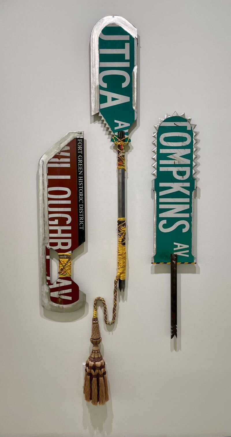 “Three Machetes,” 2021 Repurposed DOT street signs, Bad Brains t-shirts, steel
