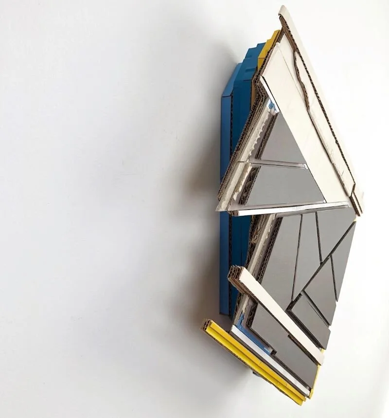 “Place-holder”, 2020. Found (unpainted) cardboard, cut book covers, foamcore 20.25 x 17 x 4in. (51.4 x 43.2 x 10.2cm)