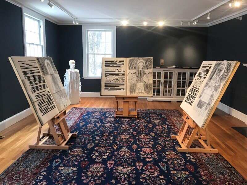 Three of the life size exquisite corpse books from The Book of Genocides