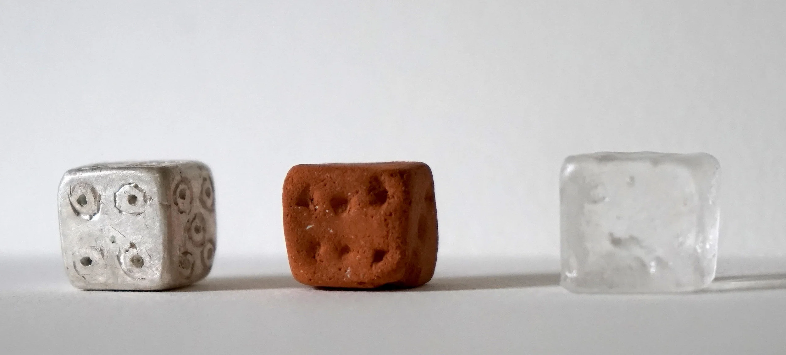 “Dice” - Materials: fired clay dug from a riverbed in Peru, lost wax silver cast, and kiln cast glass