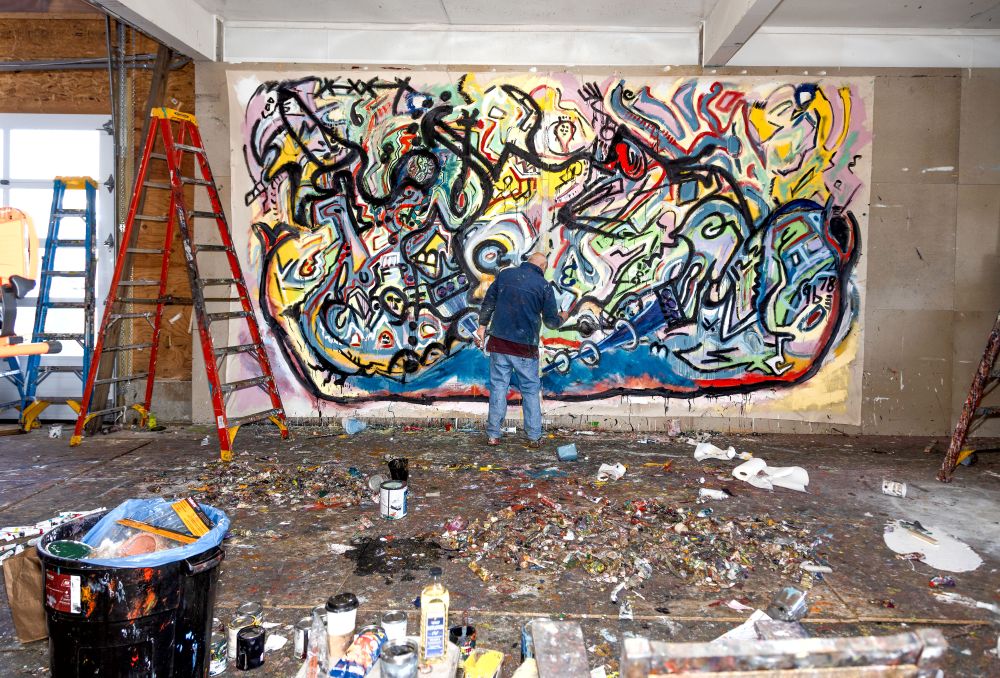 Gordon Massman at work on giant canvas